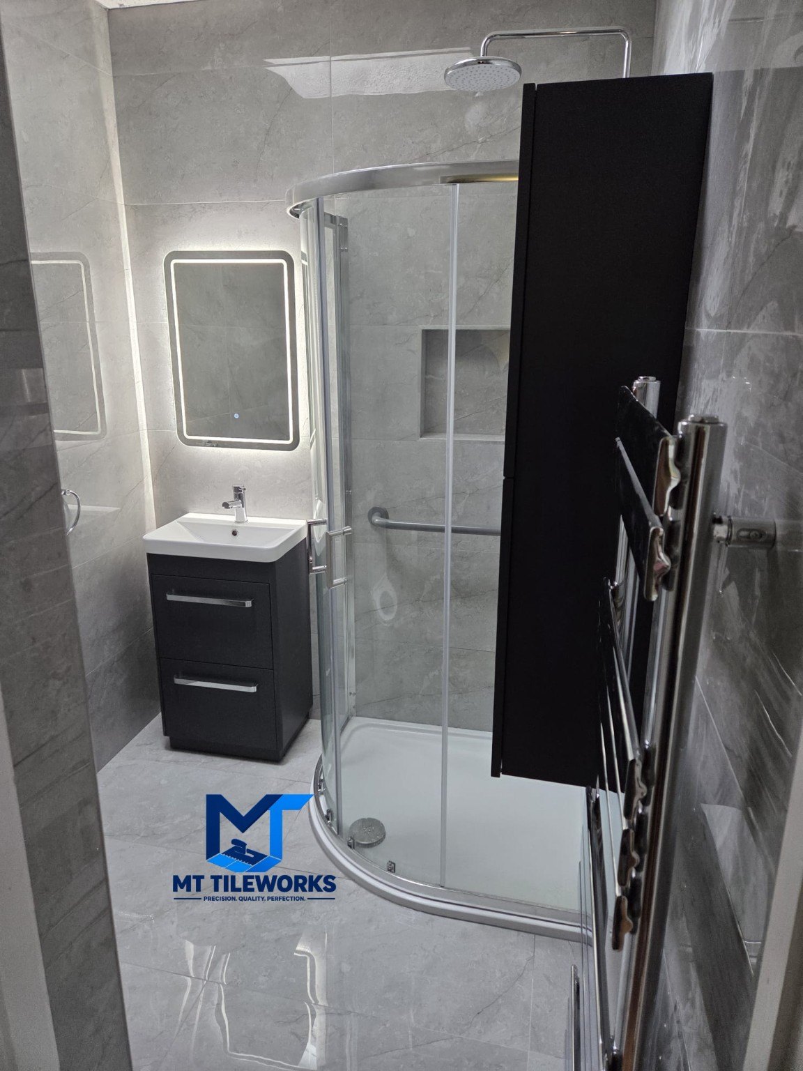 Completed grey tiled bathroom and shower
